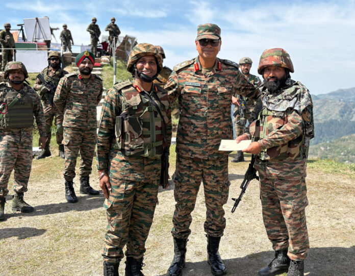 Lt Gen PK Mishra posing with soldiers while presenting an award to one of them at Dogrian area in Poonch on Tuesday.