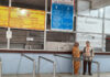 A mother and daughter waiting anxiously at the closed OPD registration counter of GMC Jammu, hoping for services to resume.
