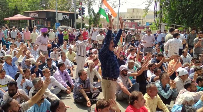 PHE daily wagers staging protest at Ranbireshwar Temple Chowk on Shalamar Road in Jammu on Wednesday. -Excelsior/Rakesh