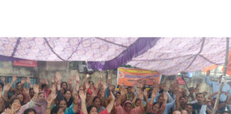Workers of M/s Hindustan Pencils Private Limited staging dharna outside the factory gate in Jammu.