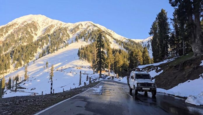 A vehicle moving on Bhaderwah-Chamba interstate road after snow clearance on Saturday. -Excelsior/Tilak Raj