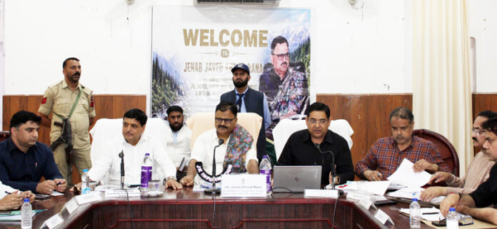 Minister Javed Rana chairing a meeting at Bhaderwah on Saturday.