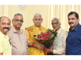 A delegation of Shiv Mandir Charitable Trust posing with LG Manoj Sinha.