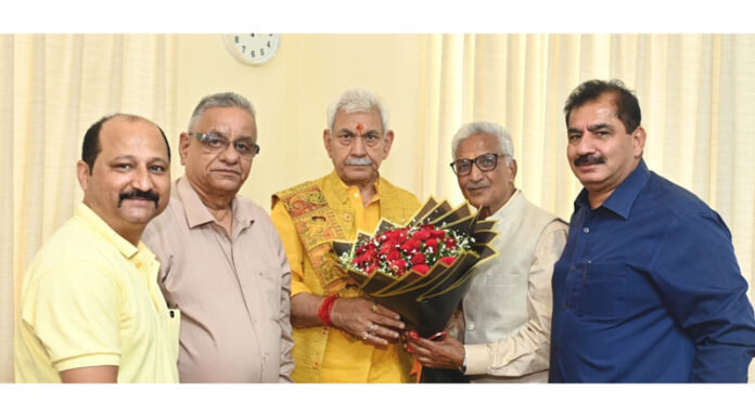 A delegation of Shiv Mandir Charitable Trust posing with LG Manoj Sinha.