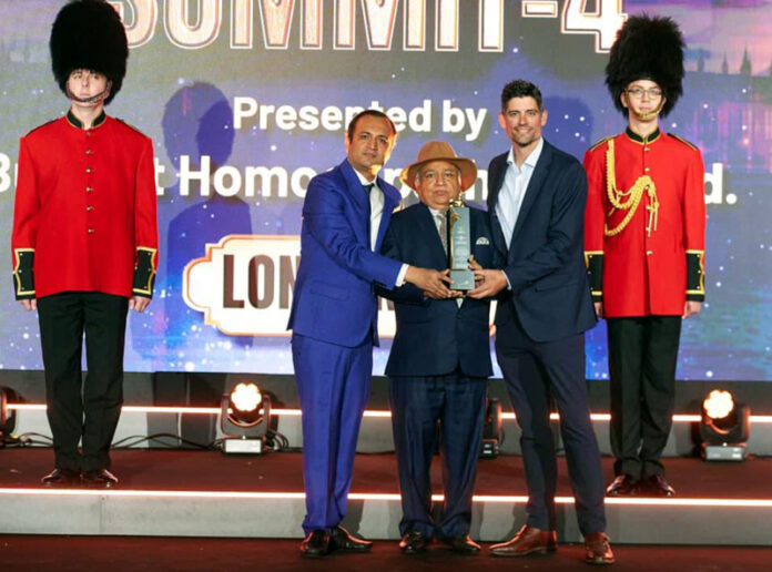 Dr Shakti Dhar Sharma receiving International Visionary Award from ex-British cricketer Alastair Cook in London.