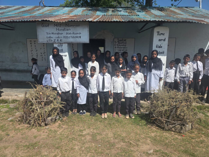 Students posing outside Government Middle School, Numman Hundian, in Mendhar tehsil of district Poonch.