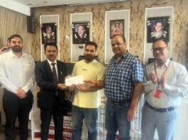 A customer being provided with a sanction letter by PNB officials at Warehouse in Jammu on Monday.