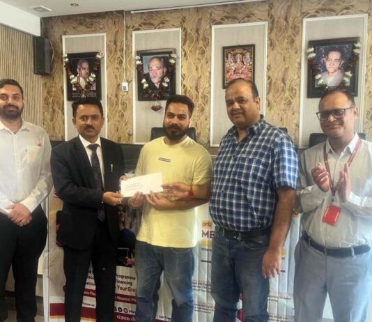 A customer being provided with a sanction letter by PNB officials at Warehouse in Jammu on Monday.