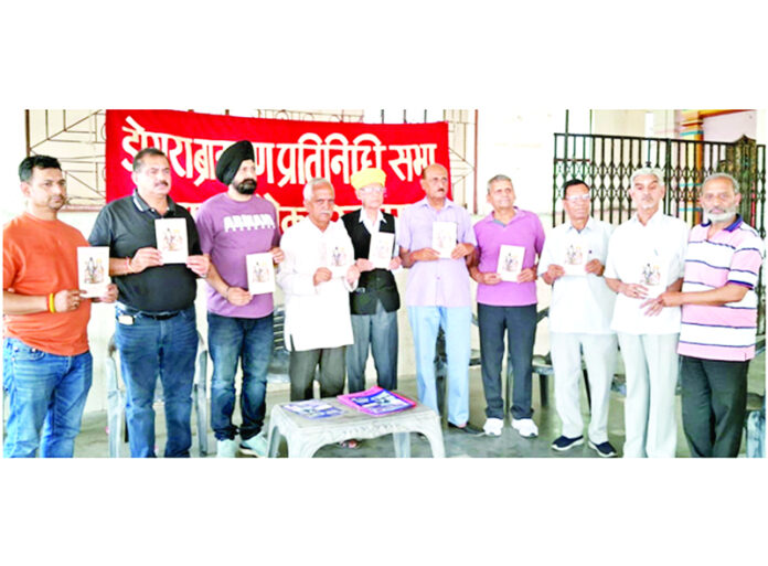 President of DBPS and others releasing calendar book on festivals and religious events.