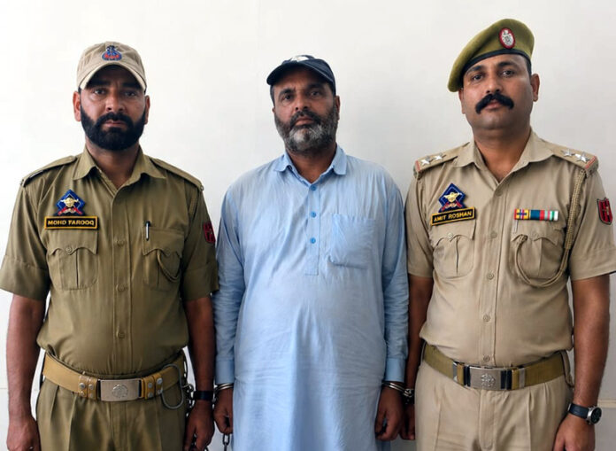 Notorious criminal in police custody.