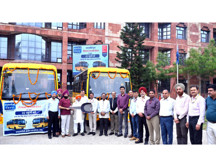 Executive Director, NHPC Regional Office, Jammu, Ram Swaroop along with others posing for a photograph after giving two school buses to BBSBET.
