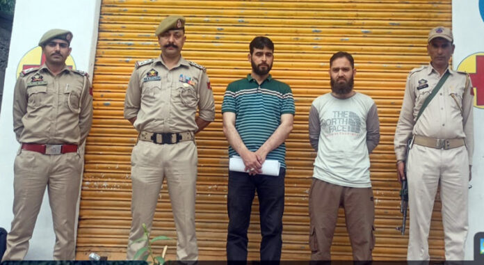 Cops and others standing outside a sealed medical shop in Ramban on Saturday. -Excelsior/ Parvez Mir