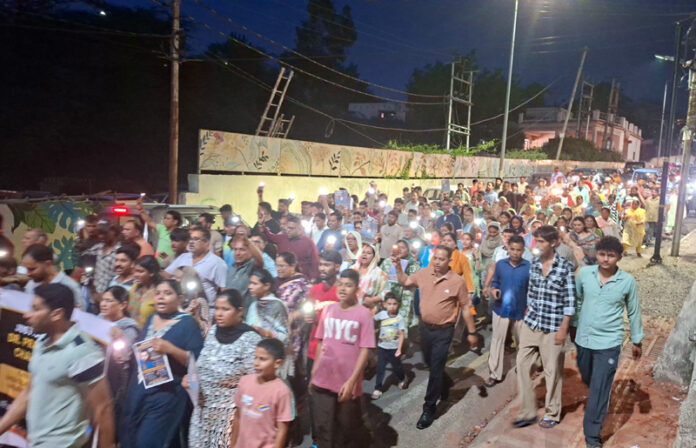 Locals carrying out a candle march at Bahu Fort area in Jammu on Tuesday.