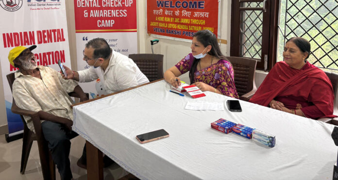 A doctor examining a patient during a dental check-up camp at Bahu Fort, Jammu.