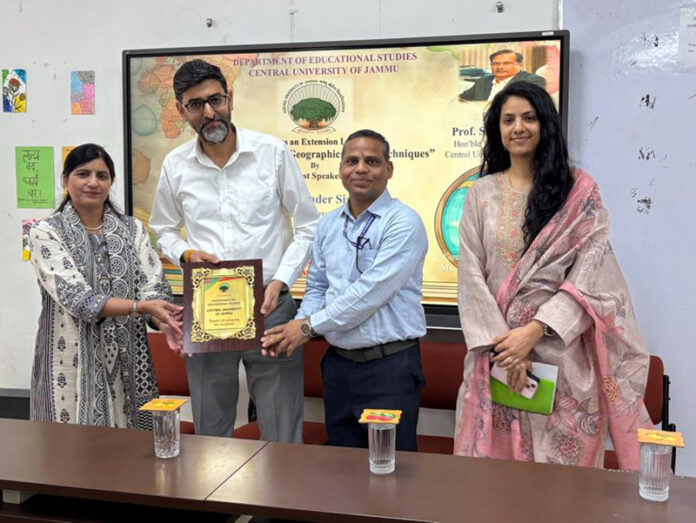 Resource person being presented memento during guest lecture at CUJ.