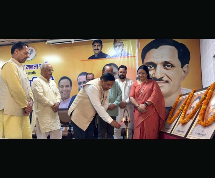 BJP leaders lighting ceremonial lamp during a meeting on Thursday.