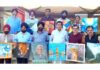 Artists posing for a group photograph during a painters camp organized in Mansar.