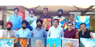 Artists posing for a group photograph during a painters camp organized in Mansar.