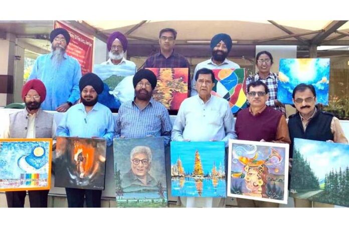 Artists posing for a group photograph during a painters camp organized in Mansar.