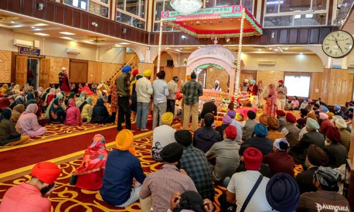 Devotees paying obeisance at Chatipadshahi Gurdwara in Srinagar on the occasion of Baisakhi on Tuesday. -Excelsior/Shakeel