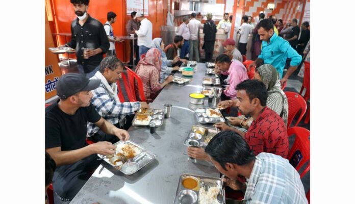 Attendants of the patients having meals at GMC Jammu's Apna Bhojanalya canteen on Thursday. -Excelsior/Rakesh