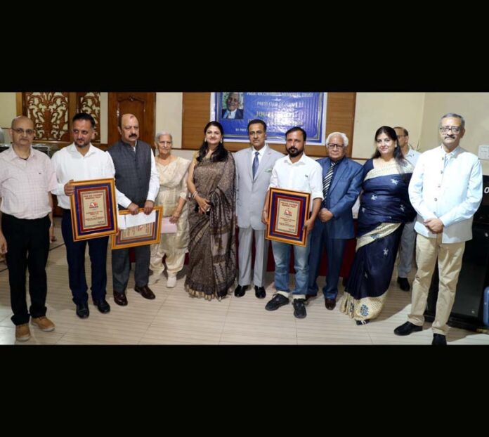 Awardees pose with Chief Justice Jammu, Kashmir and Ladakh High Court Justice Arun Palli, Press Club president Sanjeev Pargal, Maneesh Chhibber and Trust members. -Excelsior/Rakesh