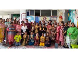 Students and others posing for a group photograph during a children's Dogri dance festival in Jammu on Saturday.