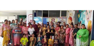 Students and others posing for a group photograph during a children's Dogri dance festival in Jammu on Saturday.