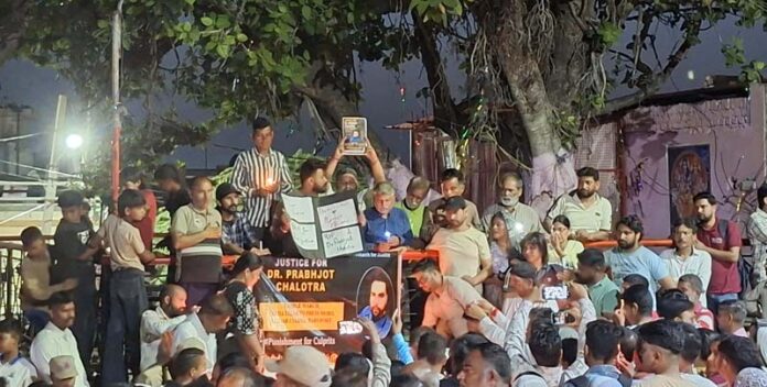 Locals taking out a candle march at Bahu Fort area on Saturday evening.