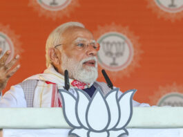 Prime Minister Narendra Modi addresses the public meeting in Barpeta, Assam on Monday. (UNI)