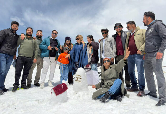 Artists of the art workshop 'Jashan-e-Bahar' enjoy the beauty of Sinthan Top in Kishtwar on Thursday.