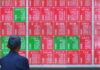 Asian shares mostly higher, tracking Wall Street's fresh records, oil prices fall