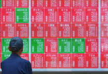 Asian shares mostly higher, tracking Wall Street’s fresh records, oil prices fall