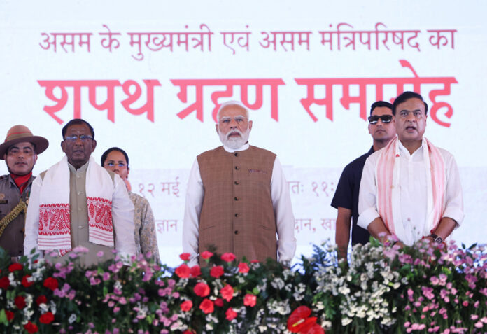 Prime Minister Narendra Modi with Assam Governor Lakshman Prasad Acharya, newly sworn-in Chief Minister Himanta Biswa Sarma, during the swearing-in ceremony, at Khanapara in Guwahati on Tuesday. (UNI )