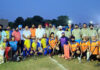 Hockey players posing along with dignitaries during a programme.