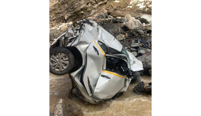 A portion of car lying in deep gorge after accident on Mughal Road in Poonch. -Excelsior/Waseem