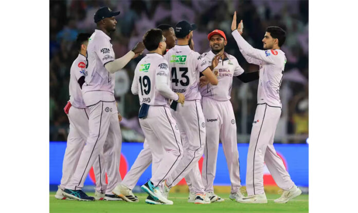 Gujarat Titans players celebrating after defeating Sunrisers Hyderabad in IPL match at Ahmedabad.