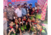 Winning team posing along with trophy during a programme.