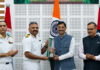 Principal, Captain (IN) Shibu Devasia receiving trophy from Minister of State for Defence Sanjay Seth in a programme.