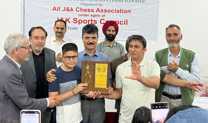 Dignitaries presenting trophy to the winner of J&K UT Level Open Chess Championship.