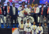 J&K Karate team posing along with trophy.