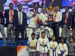 J&K Karate team posing along with trophy.