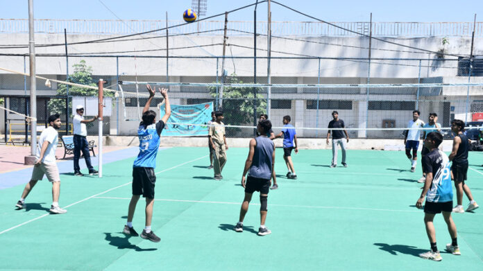 Players in action during a volleyball match on 2nd day of Inter-Zonal District Level Competitions at a venue in Jammu.