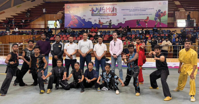 Dignitaries posing along with Wushu players during an event.