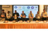 Dignitaries on dais releasing workshop souvenir.