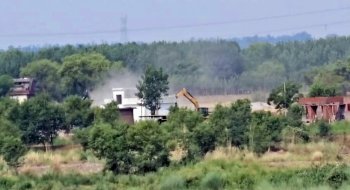 House of drug peddlers being demolished in Korepunnu area of Kathua district on Monday. -Excelsior/Pardeep