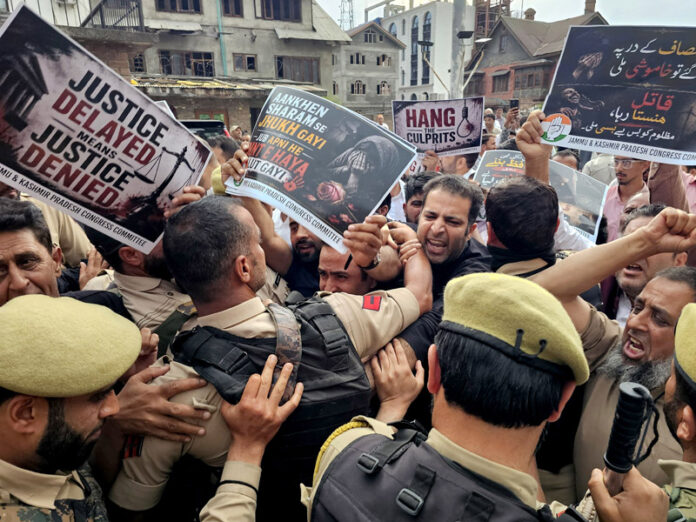 Protesting Congress leaders and workers being stopped by police in Srinagar. -Excelsior/Shakeel Protesting Congress leaders and workers being stopped by police in Srinagar. -Excelsior/Shakeel