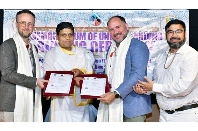 Dignitaries from Patanjali Research Foundation and Southern Cross University of Australia posing for a photograph after inking MoU.