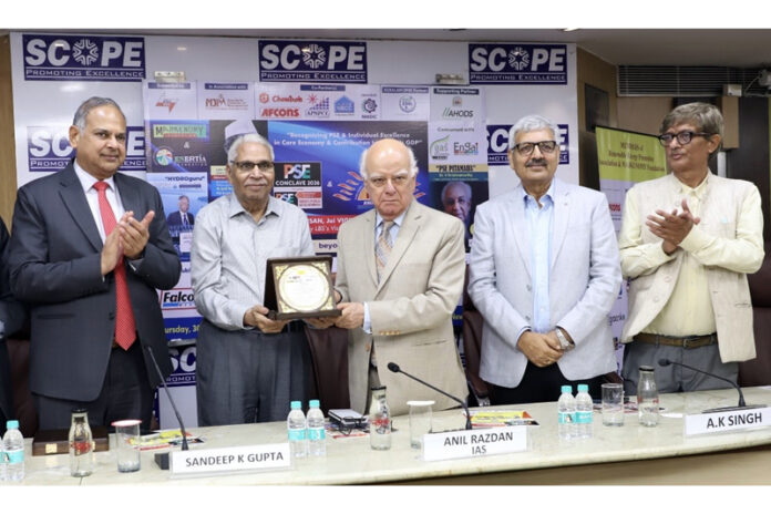 Anil Razdan, former Secretary (Power) honouring K M Prashanth and J P Sharma during a function on Friday.