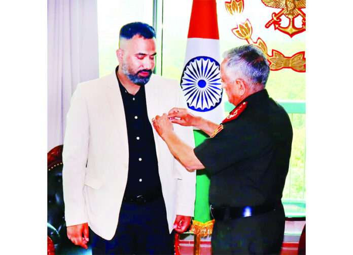 Aabid Nabi being conferred with the CDS Commendation Card by General Anil Chauhan in New Delhi on Saturday.